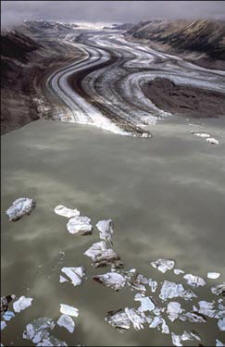 Alsek and Tatshenshini Rivers - After two days of floating through spectacular alpine scenery, you enter Lowell Lake. The receding Lowell Glacier left a basin, forming the lake. The glacier now ''calves'' ice bergs which float in the lake water.